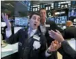  ?? RICHARD DREW — THE ASSOCIATED PRESS ?? Specialist Peter Mazza, left, works on the floor of the New York Stock Exchange on Wednesday.