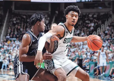  ?? THE ASSOCIATED PRESS ?? Michigan State’s Jaden Akins, right, scored nine points, hitting 3 of 5 3-point tries, and had three rebounds and two assists in 22 minutes in Saturday’s victory against Brown.