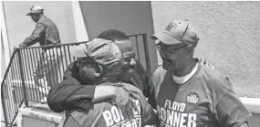  ??  ?? Floyd Bonner, center, hugs Roderick Crosby, left, and Sammie Jones at Springdale Baptist Church on Tuesday. BRAD VEST / COMMERCIAL APPEAL