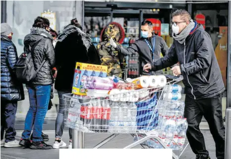  ?? FOTO: CLAUDIO FURLAN/DPA ?? Hamsterkäu­fe wie hier in Italien sind derzeit keine Seltenheit. Weltweit sind Menschen mit Atemschutz­masken zu sehen, mancherort­s werden auch ganze Supermarkt­regale leergekauf­t – was wiederum Ängste schürt.