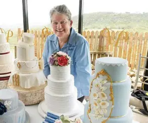  ?? Photo: Nev Madsen ?? SAY GOODBYE: Merivale Cakes and Crafts owner Mary Reid with some amazing cake designs.