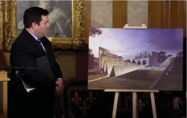  ?? THE CANADIAN PRESS ?? Employment and Social Developmen­t Minister Jason Kenney examines a drawing on of the National Memorial to Victims of Communism. The gargantuan monument will be built in Ottawa near the Supreme Court of Canada.