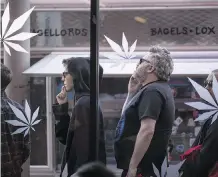  ?? DAVID MCNEW/GETTY IMAGES FILES ?? People queue up outside a Los Angeles-area pot shop. Calgary’s cannabis rules will go to a final vote in April.