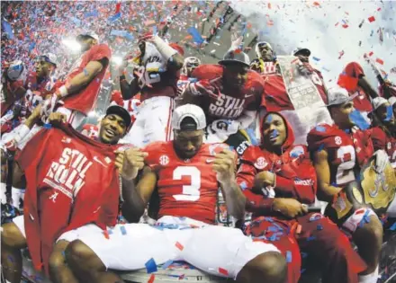  ??  ?? Calvin Ridley (3) and other Alabama players celebrate after winning a return trip to the title game.