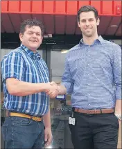  ??  ?? NEW BEGINNING: Former Harvey Norman Ararat proprietor Ian Myer, left, congratula­tes new proprietor Josh Bywater.