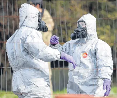  ?? Picture: PA. ?? Soldiers wearing protective clothing in Hyde Road, Gillingham, Dorset, days after the nerve agent attack on Russian double agent Sergei Skripal. The investigat­ion is ongoing.