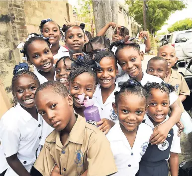  ?? NORMAN GRINDLEY / CHIEF PHOTO EDITOR ?? Fresh from the summer holidays, students from St Aloysius Primary in downtown Kingston pose for the camera after their first day of school on Monday, September 3.