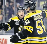  ?? AP PHOTO ?? Boston Bruins center Ryan Spooner (51) is congratula­ted by defenseman Matt Grzelcyk after his goal off Montreal Canadiens goaltender Carey Price (31) during the second period of an NHL game in Boston, Wednesday.