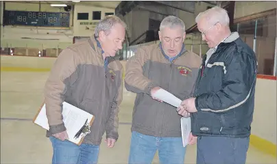  ?? JULIE COLLINS PHOTOS/CAPE BRETON POST ?? From left, Charles Hawboldt and John MacPherson with the Sydney Mines Volunteer Fire Department go over plans for the fourth annual Fishing and Hunting Outdoor Weekend with Clint Lettice of the Sydney Mines and District Community Centre.