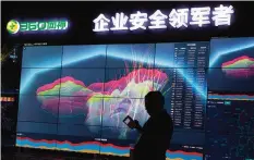  ?? —AP ?? BEIJING: In this Aug 16, 2016 file photo, a worker is silhouette­d against a computer display showing a live visualizat­ion of the online phishing and fraudulent phone calls across China during the 4th China Internet Security Conference (ISC).