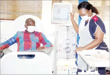  ?? (Pic: Sithembile Hlatshwayo) ?? Abel Vilakati being measured his BP by staff nurse Ncane Hlatshwako as he prepares him for the dialysis session.
