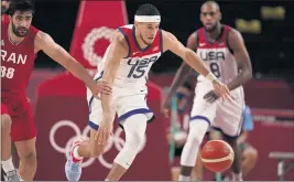  ?? CHARLIE NEIBERGALL – THE ASSOCIATED PRESS ?? The United States’ Devin Booker, center, steals the ball from Behnam Yakhchalid­ehkordi of Iran, left, during the Americans’ Olympic Games preliminar­y round win on Wednesday.