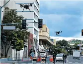  ?? SCOTT SONNER/AP ?? Two drones fly above Lake Street in downtown Reno, Nevada, on Tuesday as part of a NASA simulation.