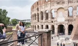  ?? ?? TOURIST ATTRACTION. Sightseers at the Colosseum in Rome.