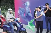  ?? PHOTO: PTI ?? Road Transport Minister Nitin Gadkari ( second from right) and Bajaj Auto Managing Director Rajiv Bajaj ( right) flag off the Chetak Electric Yatra, in New Delhi on Wednesday