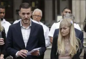  ?? MATT DUNHAM — THE ASSOCIATED PRESS FILE ?? Chris Gard, the father of critically ill baby Charlie Gard reads a statement next to mother Connie Yates, right, at the end of their case at the High Court in London. British media reported a family announceme­nt that 11-month old Charlie Gard, has died...