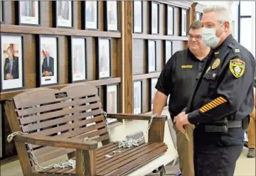  ?? Jeremy stewart ?? Cedartown police Capt. Henry Runyan (right) thanks Cedartown Chief Jamie Newsome (not pictured) and Assistant Chief Greg Cooper after being presented with a handmade wooden swing in honor of his retirement during the meeting of the Cedartown City Commission on Monday, July 13.