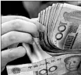  ?? EUGENE HOSHIKO/AP 2010 ?? The yuan, also known as the or “people’s money,” has fallen almost 10 percent against the dollar since April.