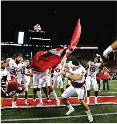  ?? KYLE ROBERTSON / COLUMBUS DISPATCH ?? When quarterbac­k Baker Mayfield tried to plant the Sooner flag in the Ohio State logo at midfield after a 31-16 win at Ohio Stadium, the statement could have spoken to the revival of an entire conference.