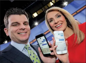  ?? Arkansas Democrat-Gazette/JOHN SYKES, JR. ?? KARK anchors and husband-and-wife Aaron Nolan and Ashley Ketz work opposite on-air schedules and keep up with each other through texts during their workdays.