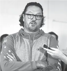  ?? ASSOCIATED PRESS ?? Australia assistant coach and former NBA star Luc Longley speaks to the media as he arrives at Brisbane airport, after the violence that marred a World Cup qualifying match between the teams on Monday.