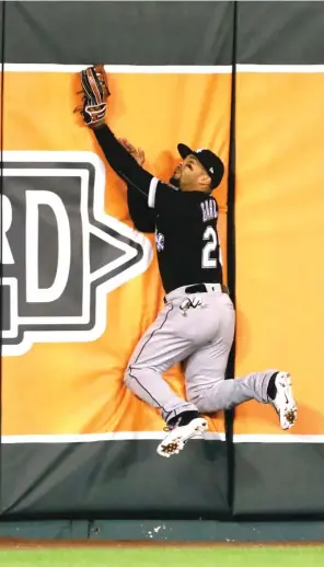  ??  ?? White Sox center fielder Leury Garcia leaps into the wall after catching a sacrifice fly hit by Royals first baseman Eric Hosmer in the sixth inning Wednesday night.
| COLIN E. BRALEY/ AP