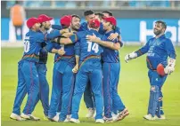  ?? Photo by Neeraj Murali ?? A proud moment for the Afghanista­n team, who celebrate after the match against India ended in a tie. —