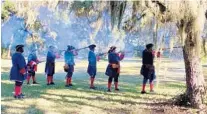  ?? ?? Reenactors demonstrat­e musket-firing on Jan. 8 at a monthly Militia Muster at Fort Mose Historic State Park — site of the first legal free Black community in North America.