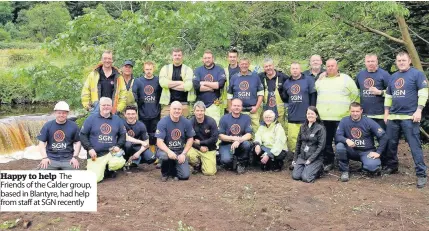  ??  ?? Happy to help The Friends of the Calder group, based in Blantyre, had help from staff at SGN recently