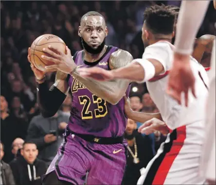  ?? Photograph­s by Luis Sinco Los Angeles Times ?? THE LAKERS’ LeBRON JAMES makes his way toward the basket against the Trail Blazers on Wednesday night at Staples Center. James came within an assist of posting a triple-double in the win but teammate Brandon Ingram shot an airball off James’ final pass.