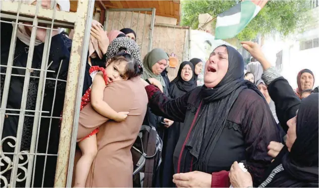  ?? Agence France-presse ?? The mother and relatives of Hamad Mustafa Hussein Abu Jelda, mourn during his funeral in the Jenin refugee camp on Sunday.