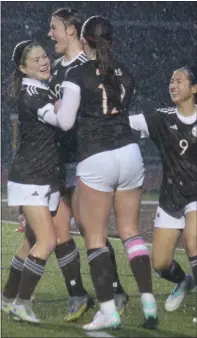  ?? ?? Rochester Adams teammates celebrate with junior Kaitlyn Dempster, second from left, following her first-half goal off a corner kick during Tuesday’s 6-0home victory over Clarkston.