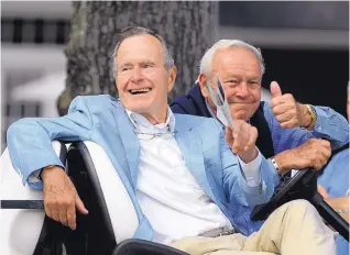  ?? PAT SULLIVAN/ASSOCIATED PRESS FILE ?? In this Oct. 22, 2010 photo, former President George H.W. Bush, left, and golfing great Arnold Palmer acknowledg­e the gallery at the Champions Tour event in Woodlands, Texas.