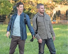  ?? KATIE YU/CW ?? Barry Allen (Grant Gustin, left) and Oliver Queen (Stephen Amell) swap bodies, abilities and heroic personas in Sunday’s episode of CW’s “The Flash,” kicking off a three-night crossover.