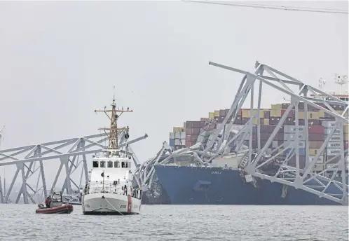  ?? ?? The US Coast Guard works at the scene after the cargo ship Dali collided with the Francis Scott Key Bridge. Joe Biden, below