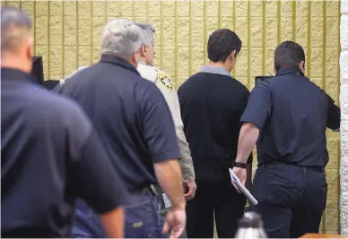  ?? ADOLPHE PIERRE-LOUIS/JOURNAL ?? Nehemiah Griego, second from right, is escorted following an appearance in Children’s Court on Monday. A judge on Thursday moved Griego from juvenile custody to the county jail.