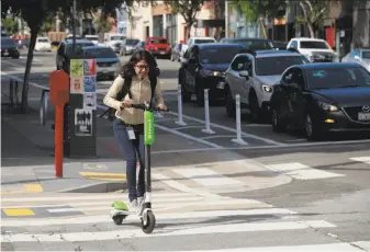  ?? Michael Macor / The Chronicle ?? Lime was among the companies that flooded San Francisco’s streets with scooters in the spring. Lime’s past “bad behavior” was one reason the city rejected its pilot-program applicatio­n.