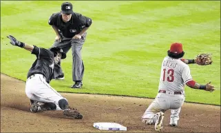  ?? LYNNE SLADKY / ASSOCIATED PRESS ?? Ichiro Suzuki slides in with a steal ahead of the throw to Philadelph­ia’s Freddy Galvis in the eighth inning after singling for his 2,997th hit. Ichiro scored on Giancarlo Stanton’s double.