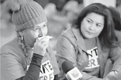  ?? Damian Dovargane/Associated Press ?? El Salvador immigrants Diana Paredes, left, and Isabel Barreral listen during a news conference Monday following an announceme­nt on Temporary Protected Status for nationals of El Salvador in Los Angeles. The Trump administra­tion said Monday it is...