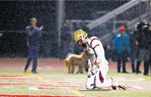  ?? Photos by Scott Strazzante / The Chronicle ?? Above, Mark Boschetti reacts late in Cardinal Newman-Santa Rosa’s 59-56 loss to Marin Catholic-Kentfield in the North Coast Section Division 3 title game. Below, Newman’s Nikko Kitchen looks to salvage workout equipment from his family’s burned home in...