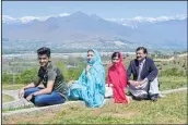  ??  ?? Pakistani activist and Nobel Peace Prize laureate Malala Yousafzai (2R), poses for a photograph along with her father Ziauddin Yousafzai (R), mother Torpekai (2L) and brother Atal Yousafzai (L) at the all-boys Swat Cadet College Guli Bagh, during her...