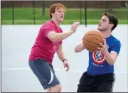  ?? NWA Democrat-Gazette/J.T. WAMPLER ?? Zach Sjogren (right) of Bella Vista and Austin Walker of Rogers play basketball Wednesday at Memorial Park in Bentonvill­e. The pair met to get some exercise and enjoy the mild weather in Northwest Arkansas.