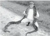  ?? BOBBY HILL/ASSOCIATED PRESS ?? Florida Lt. Gov. Carlos Lopez Cantera on May 15 with a 15-foot-4-inch python caught in the Everglades.