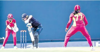  ?? CWI MEDIA PHOTO ?? New Zealand’s Maddy Green (centre) on the go during her Player of the Match performanc­e against the West Indies in Antigua and Barbuda yesterday. Green made 48 in New Zealand’s two-wicket win.