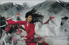  ?? JASIN BOLAND — DISNEY VIA AP ?? Yifei Liu in the title role of “Mulan.” Last month, Walt Disney Co. experiment­ed with the $200 million “Mulan” as a premium buy on its fast-growing streaming service, Disney+, where the Pixar film “Soul” will also go on Dec. 25.