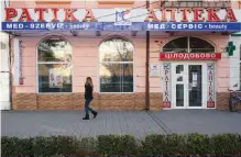  ??  ?? A picture shows inscriptio­ns in two languages, Ukrainian and Hungarian, on a local pharmacy in Beregove, a small town in western Ukraine.