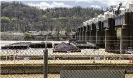  ?? WTAE VIA AP ?? More than two dozen river barges broke loose from their moorings and floated down the Ohio River, damaging a marina and striking a bridge.