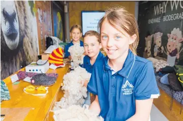  ?? Photo / Supplied ?? Havelock North Primary School students Ruby O’Sullivan (front), Tessa O’Sullivan and Bella Biggs showing off how interactiv­e The Wool Shed can be.