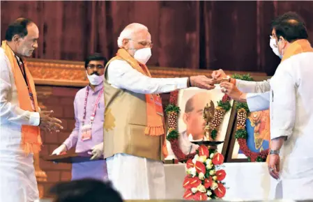  ?? ?? PRIME MINISTER Narendra Modi lighting the ceremonial lamp to kick-start the BJP national executive meeting in Hyderabad on July 3 as party president J.P. Nadda and national OBC president K. Laxman look on.