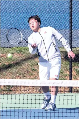  ??  ?? Tim Kim, Ringgold’s No. 1 singles player, returns a shot during a match against Haralson County. Kim won the match, 6-0, 6-0. (Catoosa County News photo/ Scott Herpst)